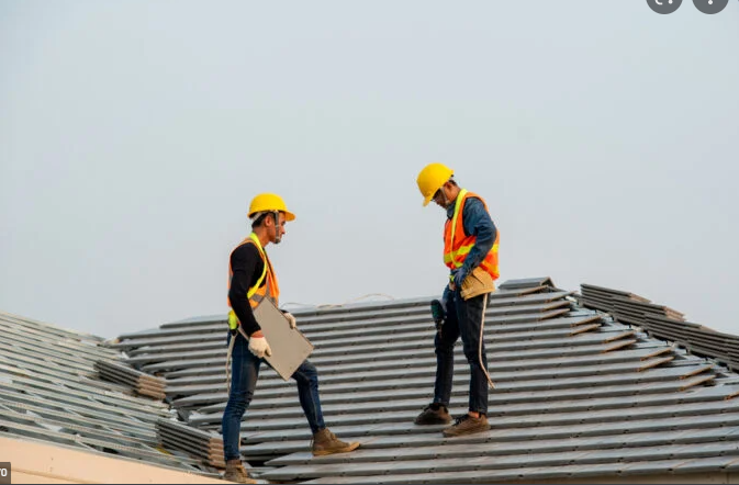 two roofers on a roof