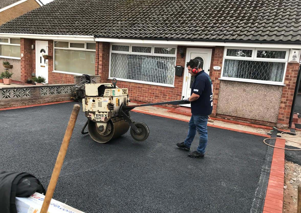 man working on driveway tarmac