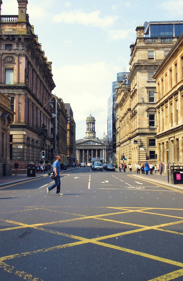 man walking across the road in Glasgow