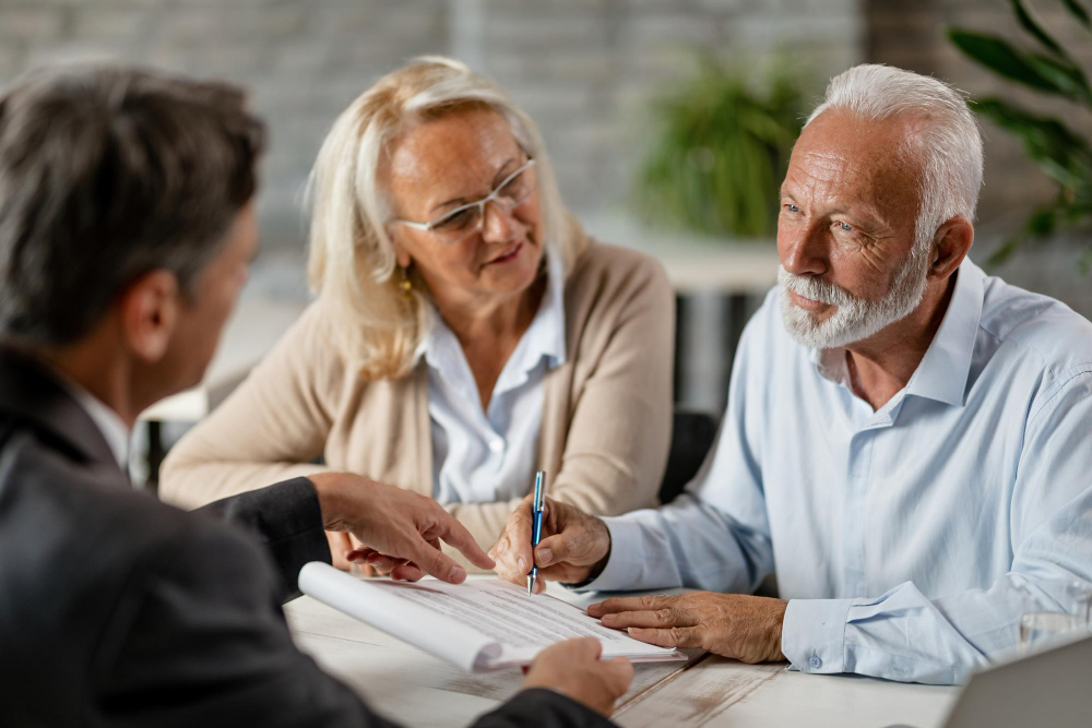 mature couple having meeting with bank manager signing lease agreement office focus is mature man